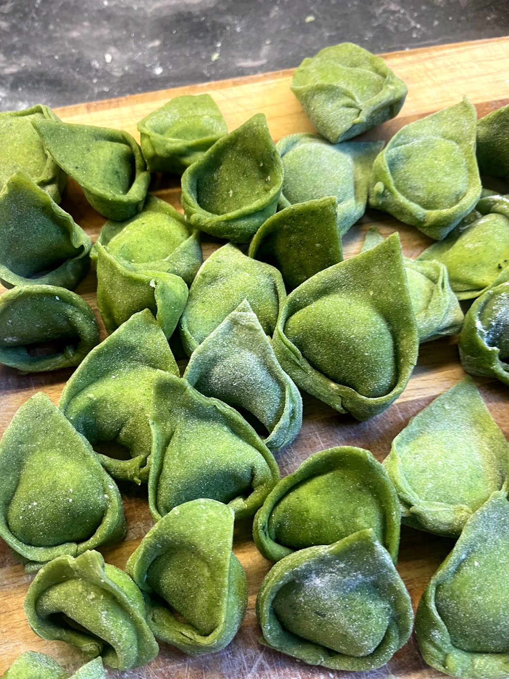 Spinach ravioli dusted with flour